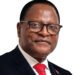 image of smiling Malawi President with eye glasses, red tie with white background.