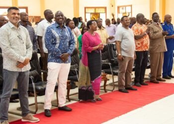 Image of President Ruto, smiles in open congregation.
