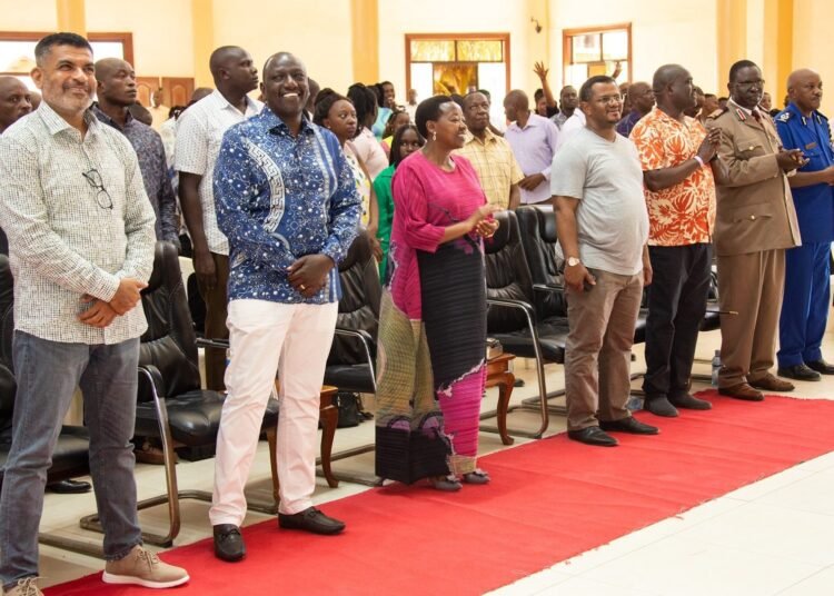 Image of President Ruto, smiles in open congregation.